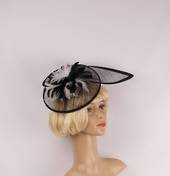 Hatinator in sinamay w blk and white feathers, a curved extended base, band, black Style: HS/3004/BLK